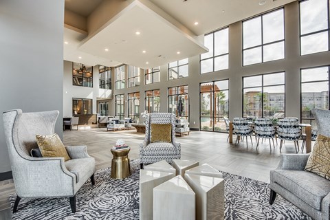 a large living room with large windows and furniture